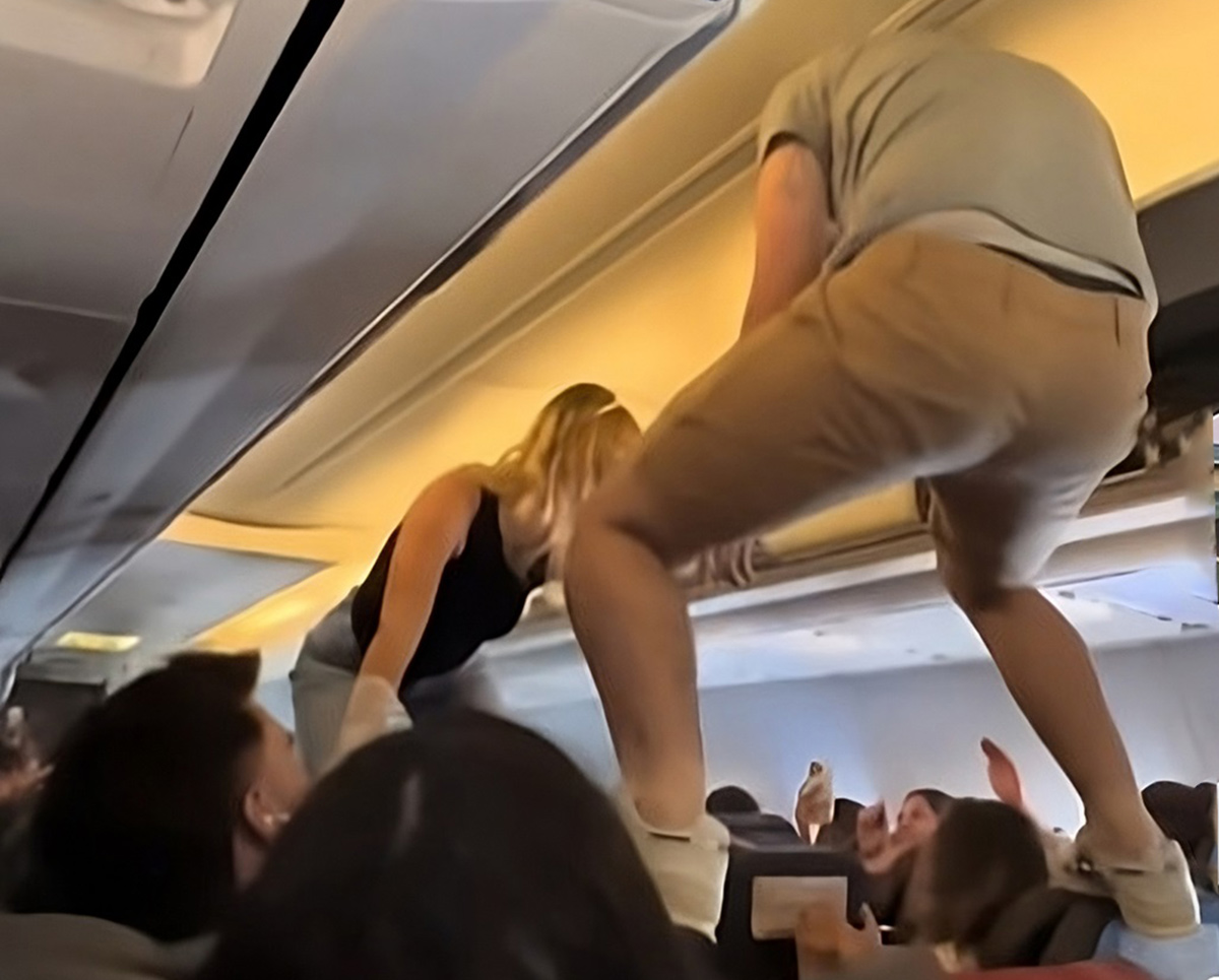 a man and woman standing on a plane