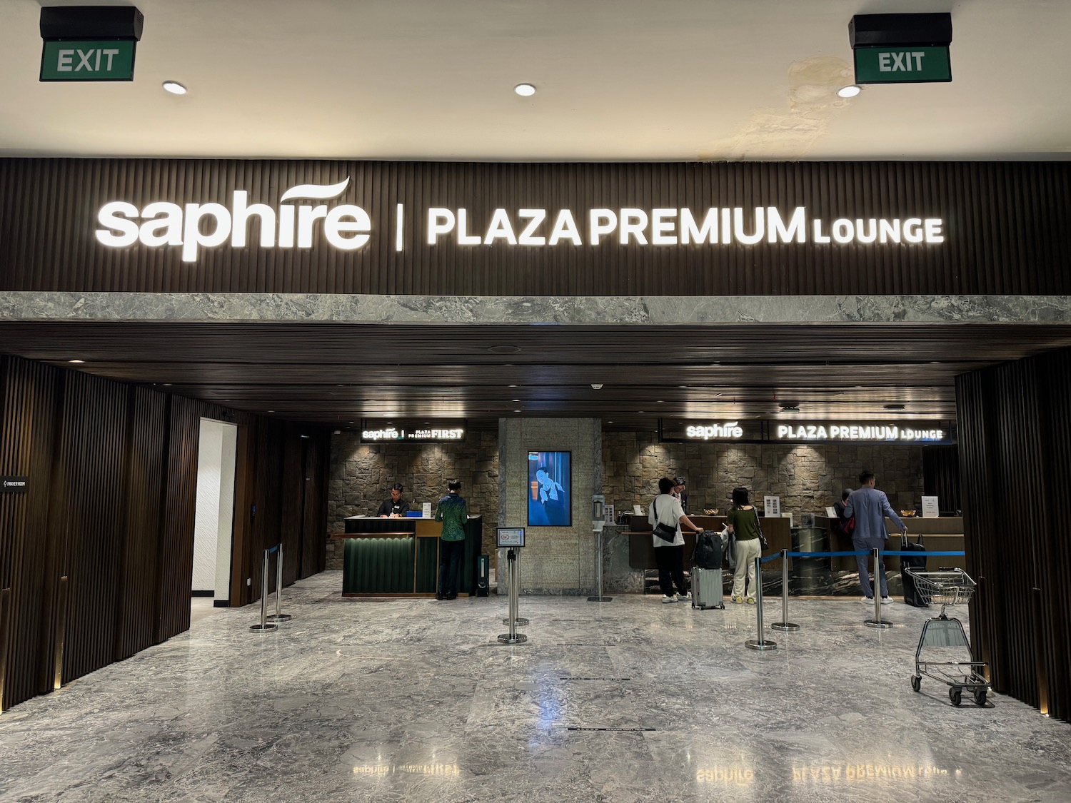 a group of people standing in front of a sign