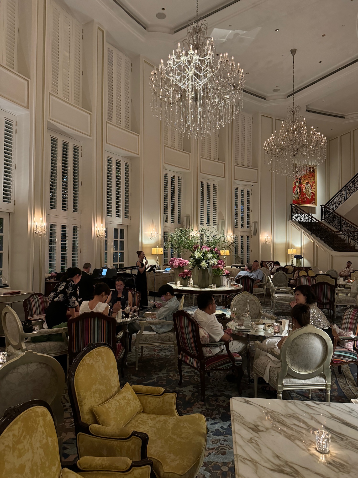 a group of people sitting at tables in a large room