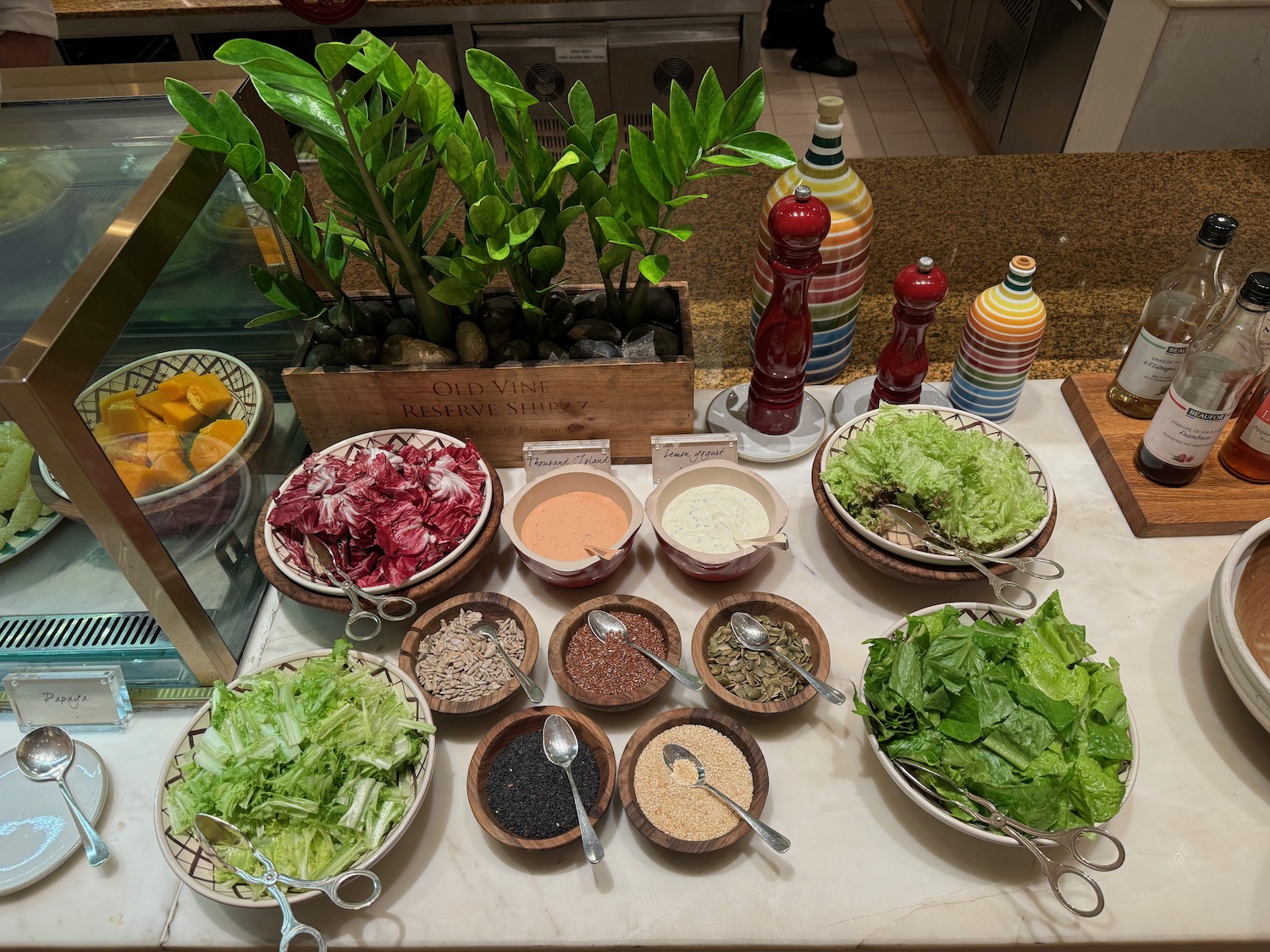 a table with bowls of food and spoons