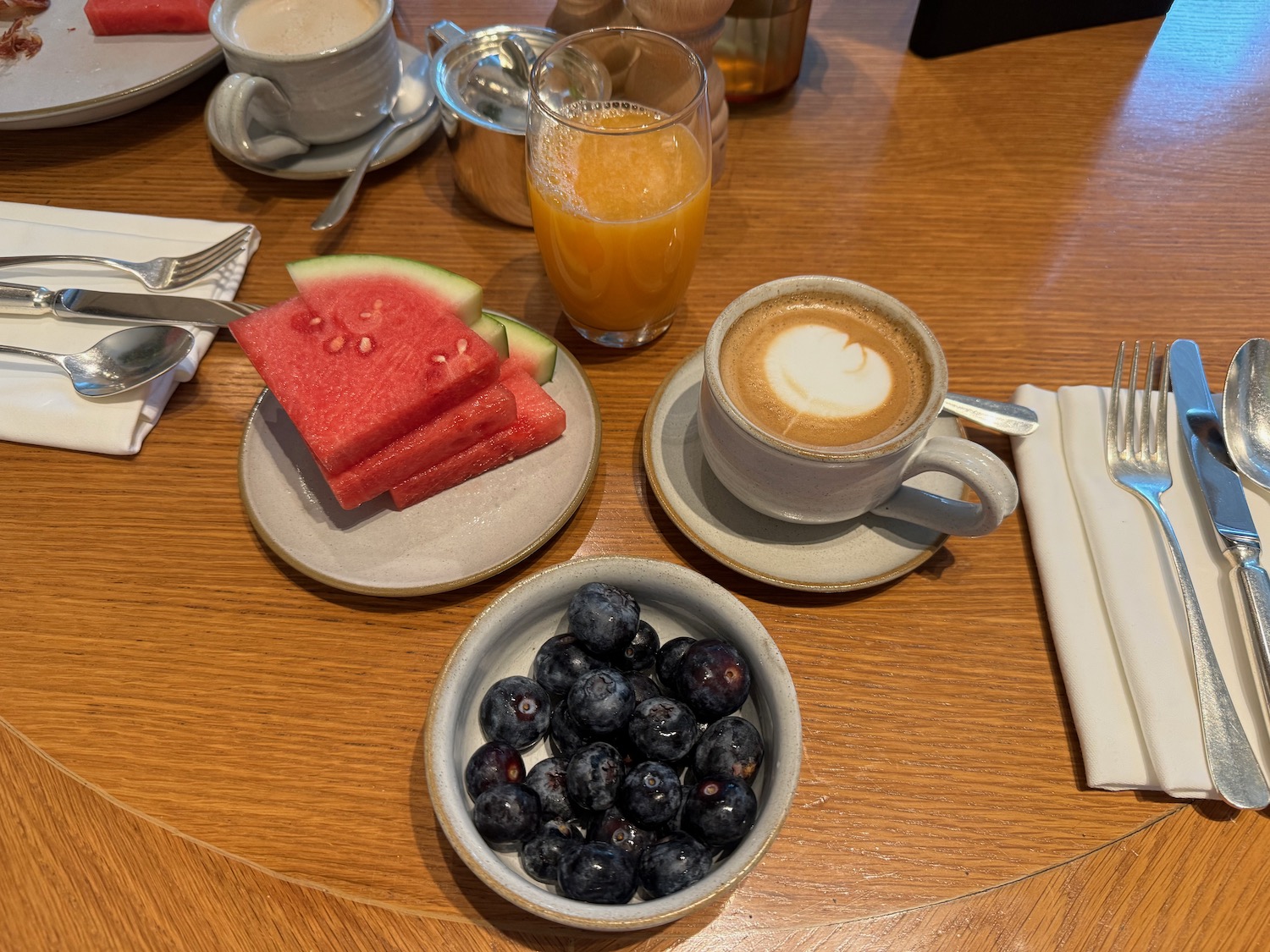 a table with plates of food and drinks