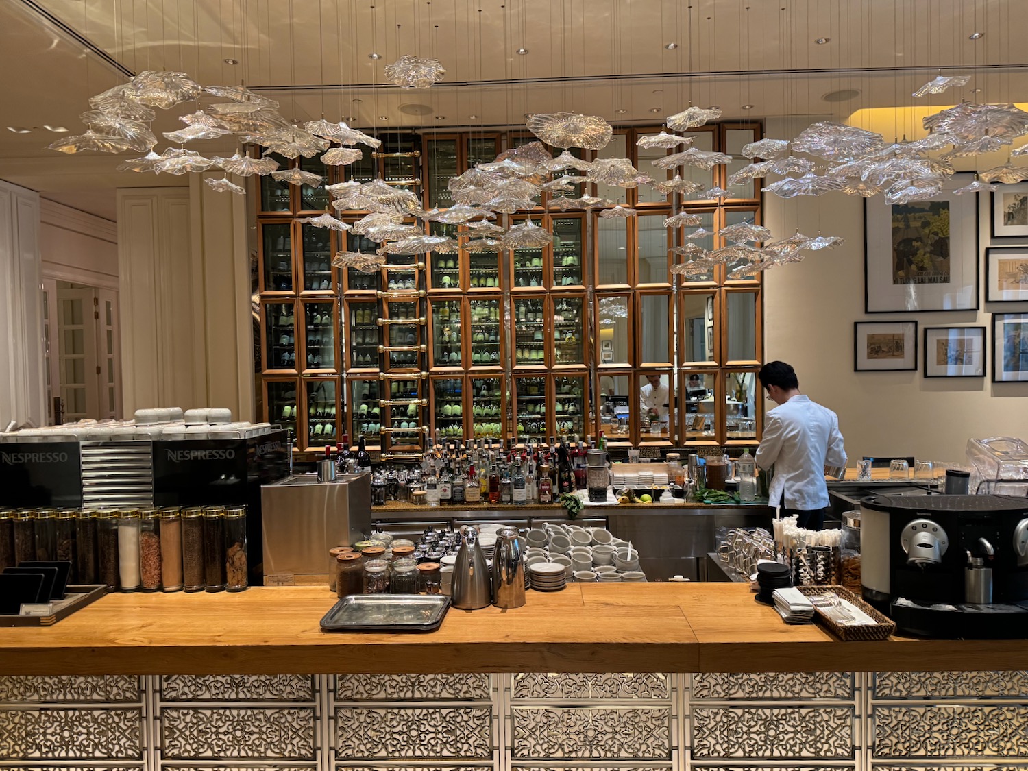 a man standing behind a counter in a restaurant