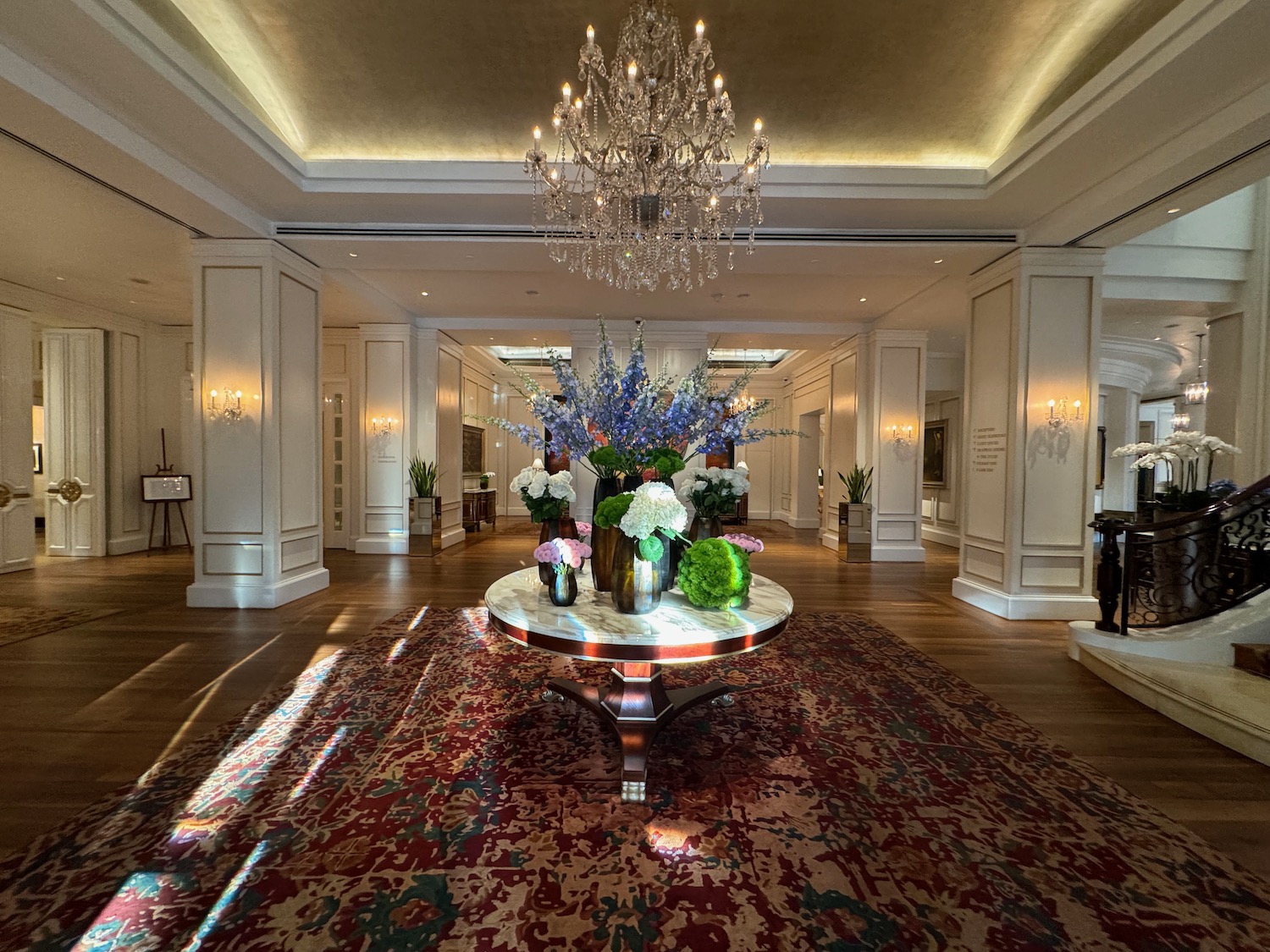 a large room with a chandelier and flowers