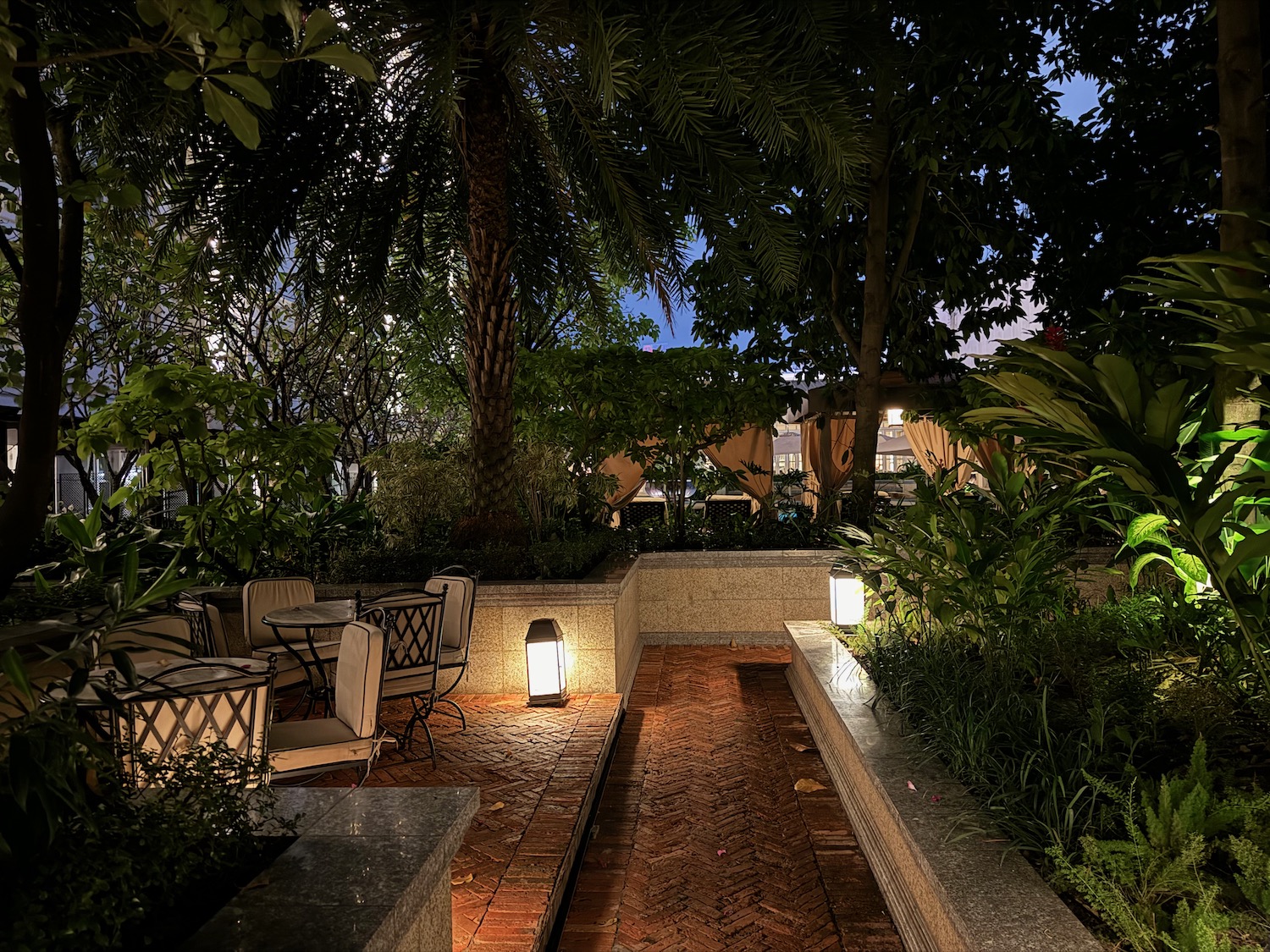 a patio with chairs and trees