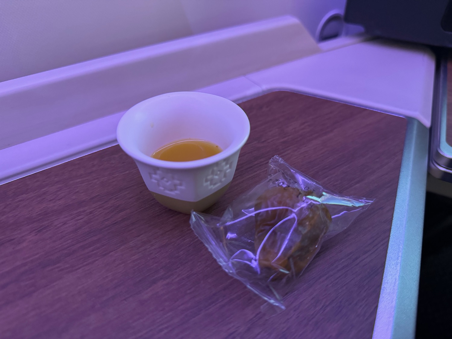 a cup of liquid and a bag of food on a table