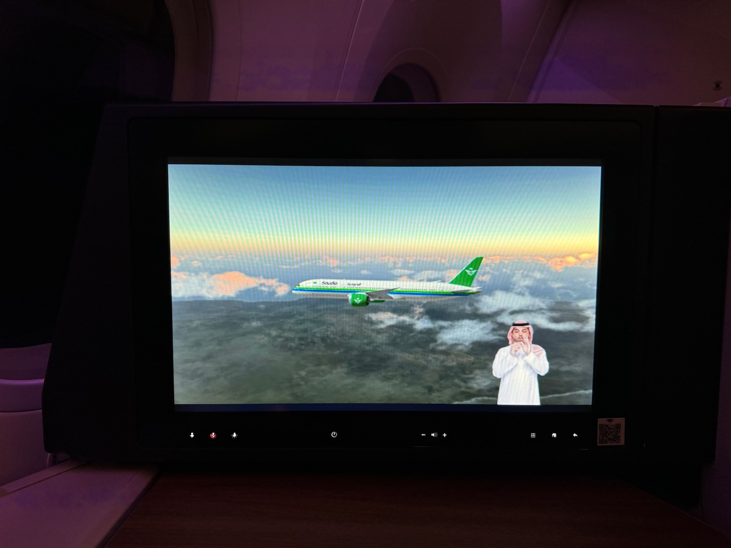 a television screen with a plane and a man taking a picture