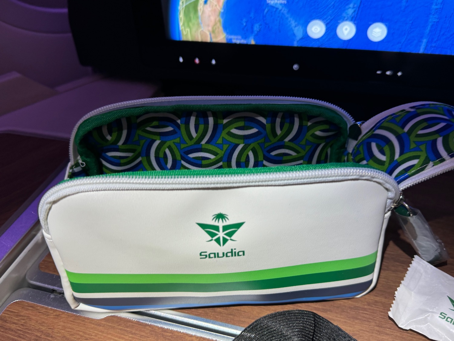 a white and green bag with a green design on it