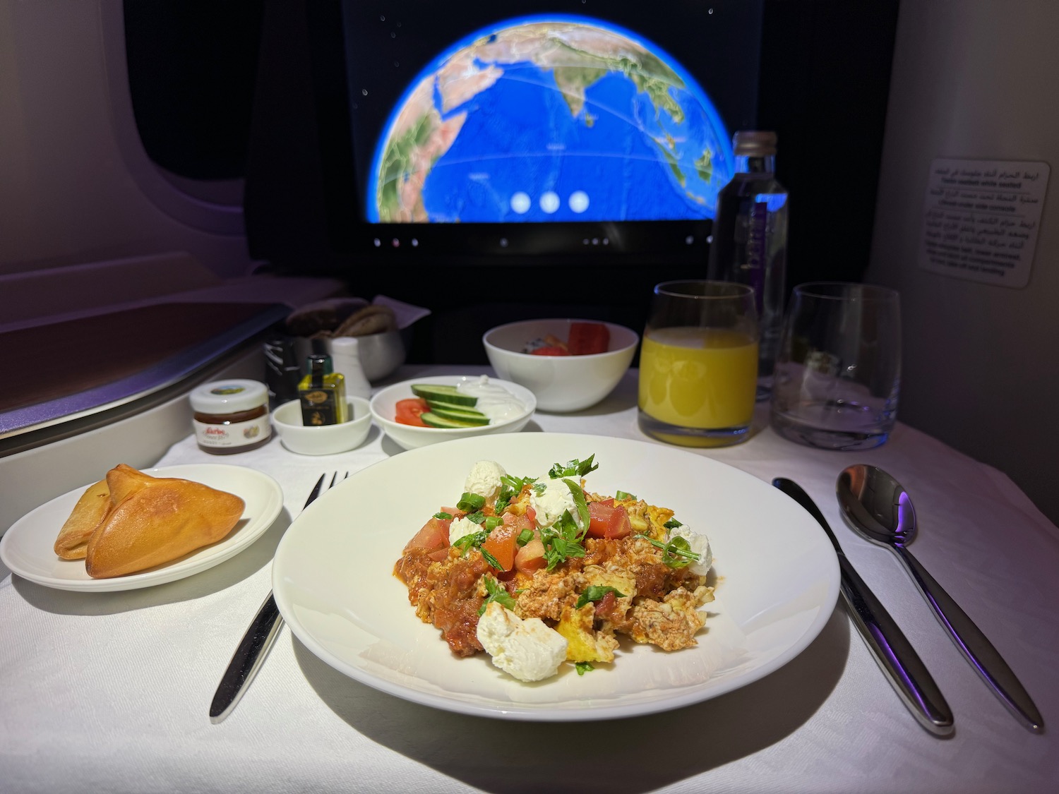 a plate of food on a table with a television in the background