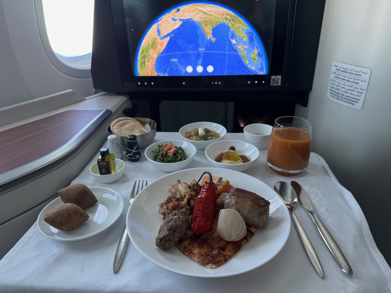 a plate of food on a table with a television in the background