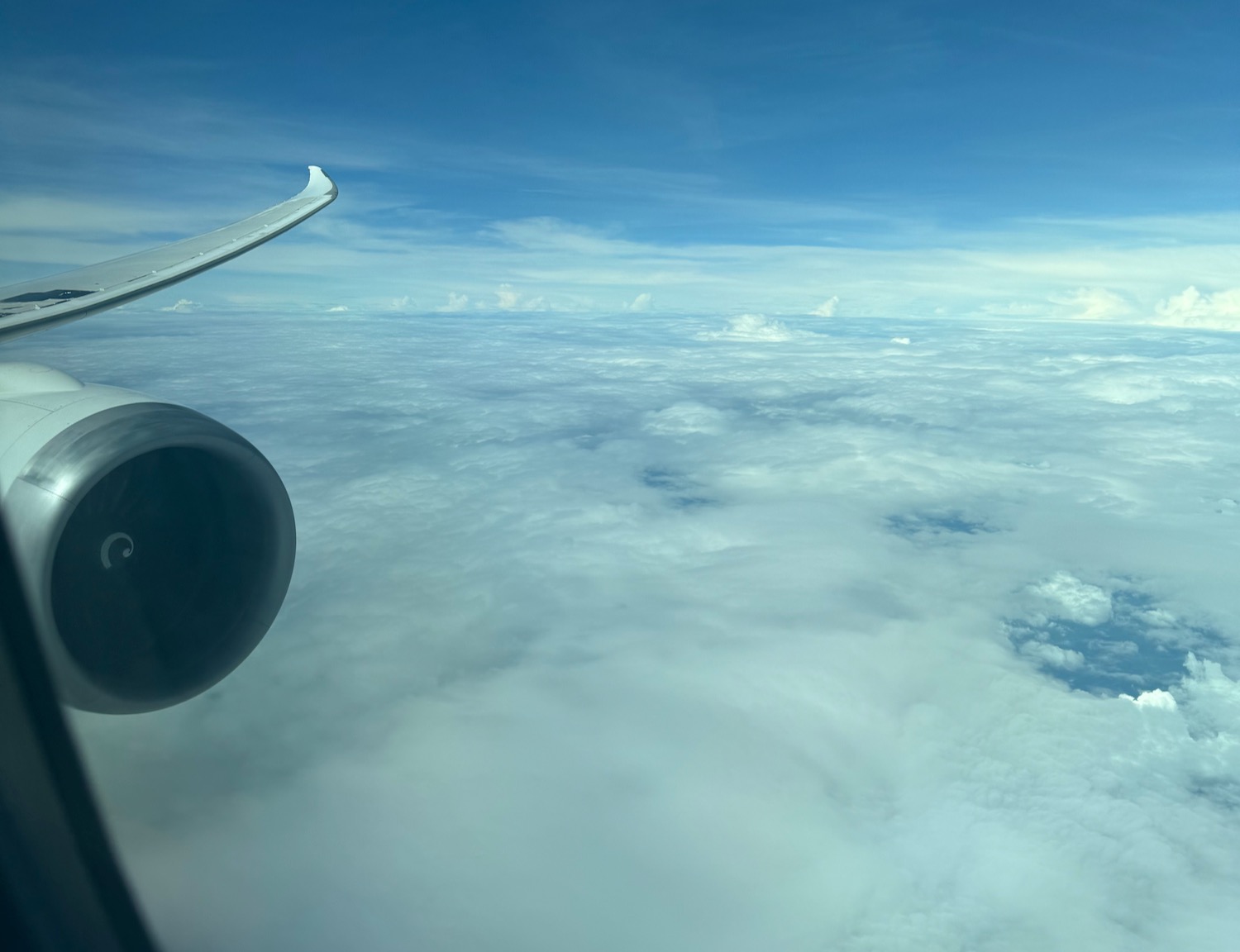 an airplane wing above the clouds