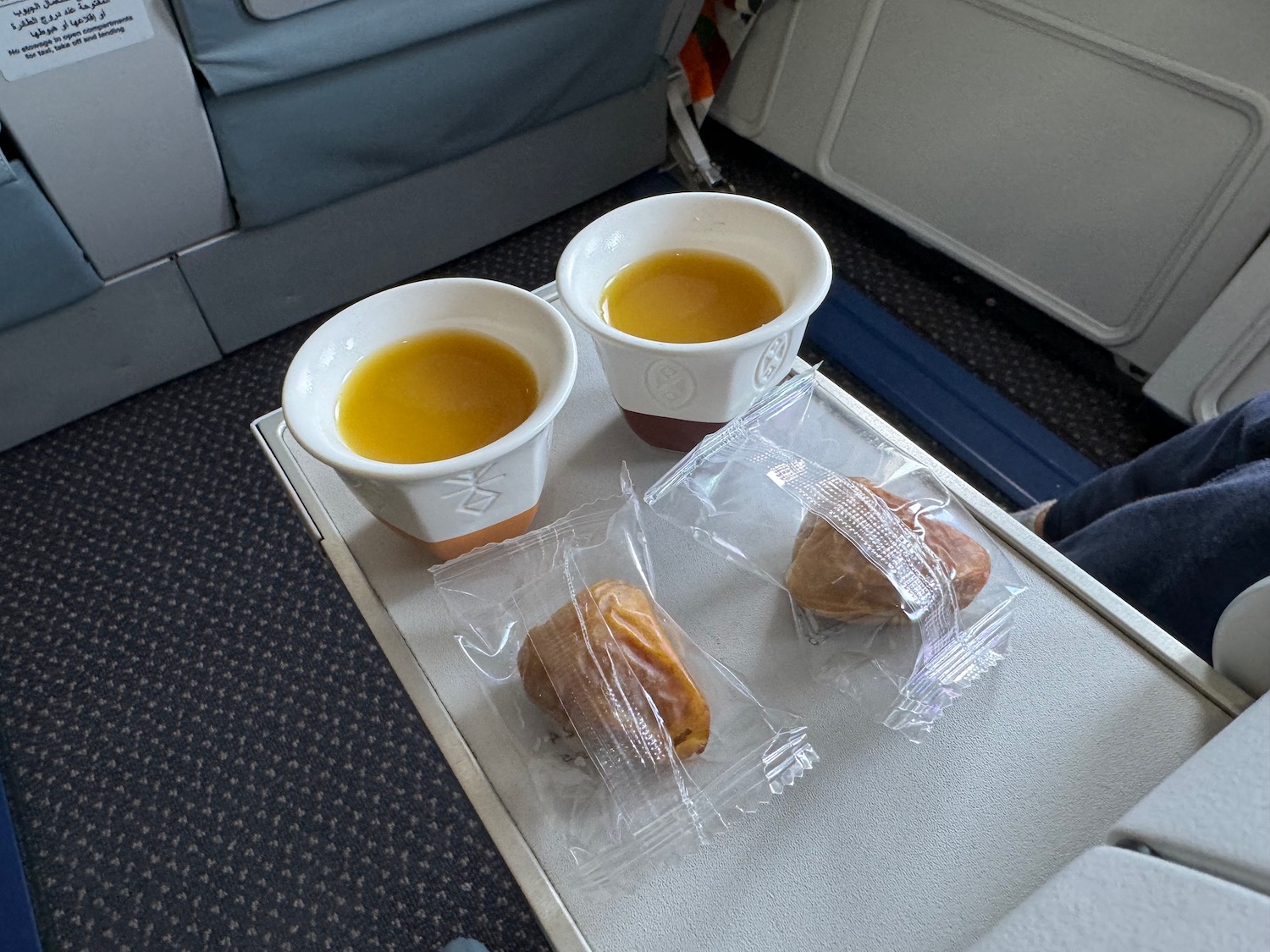 a tray with cups of food and drinks on it