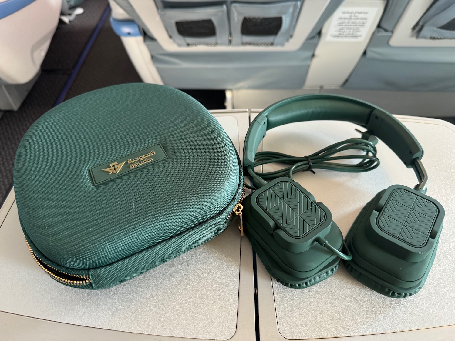 a green headphones and a case on a table