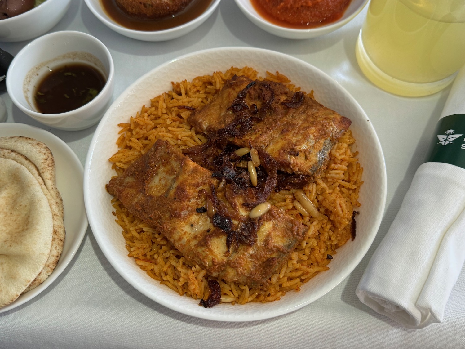 a plate of rice with meat and sauces