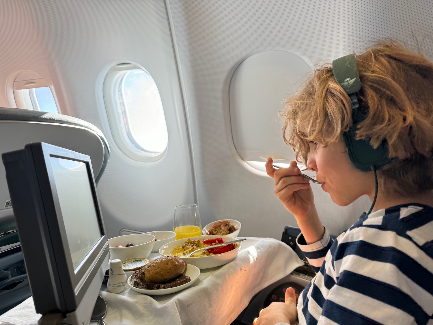 a person eating food on an airplane