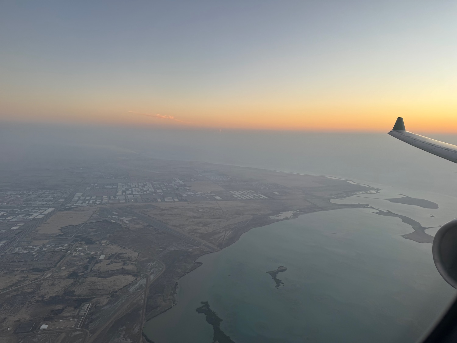 an airplane wing over a body of water