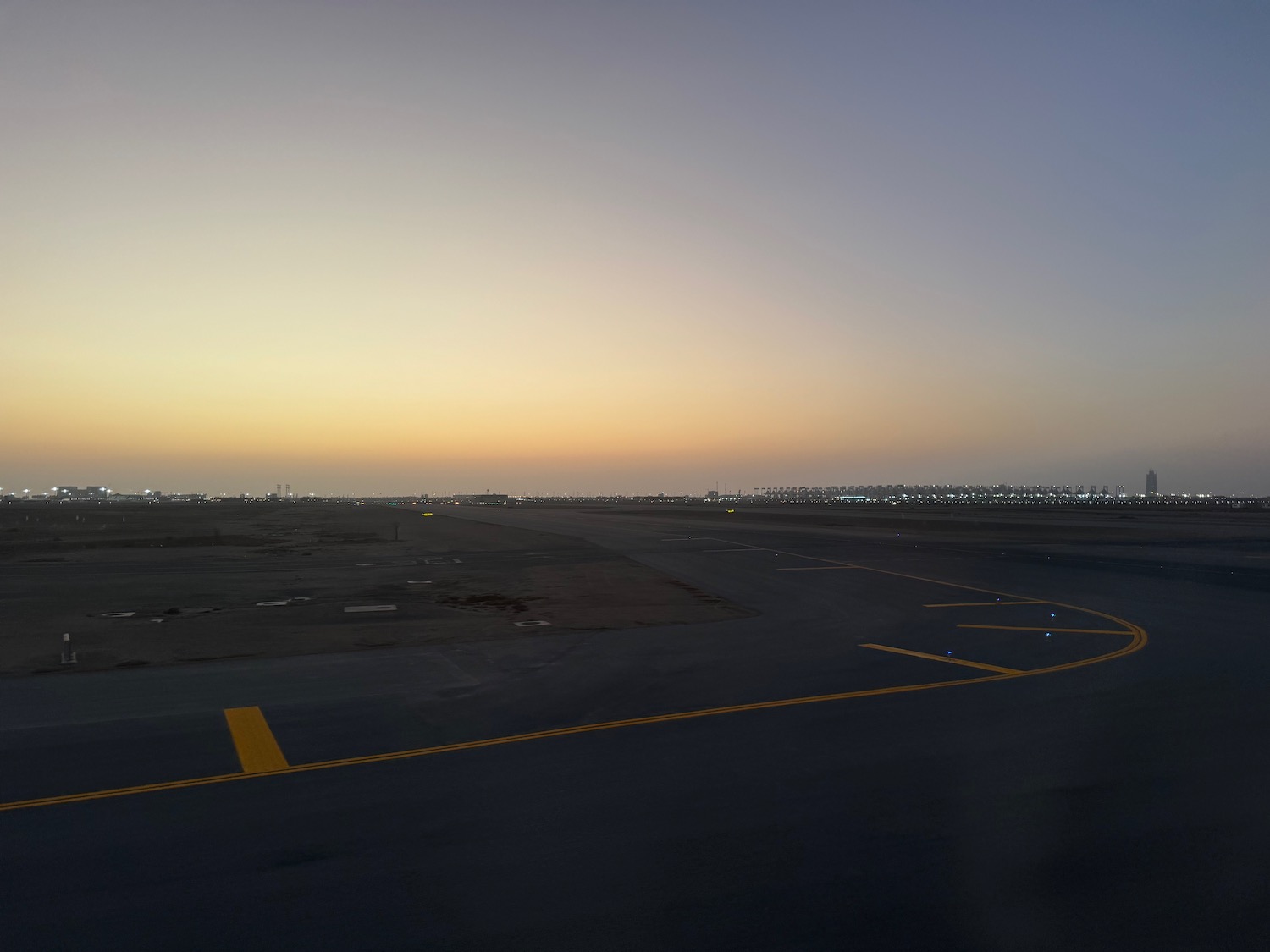 a runway with lights on the ground