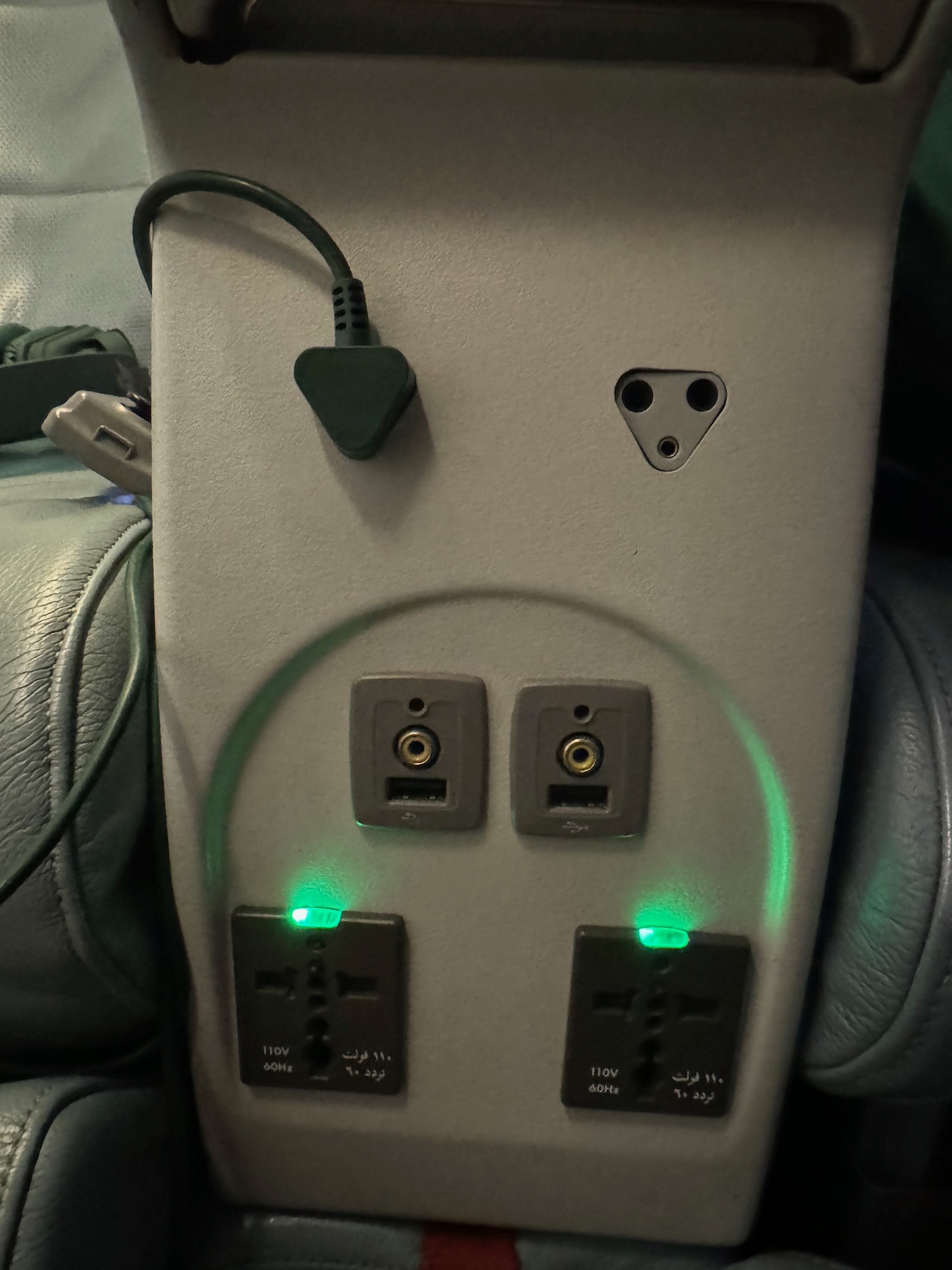 a power outlet with plugs and green lights