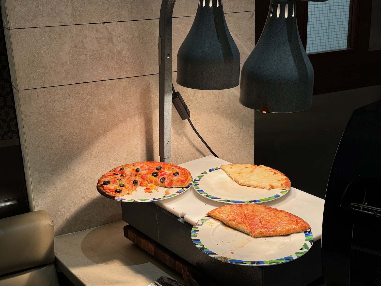 a pizza on plates on a counter