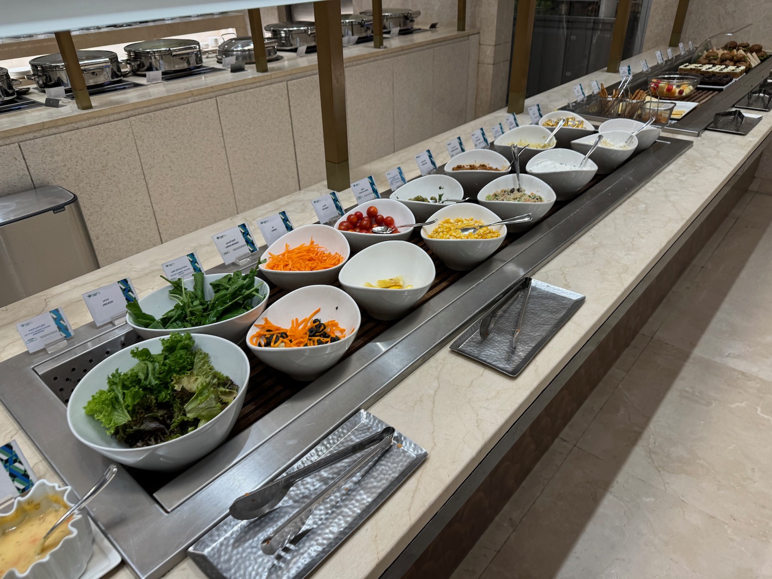 a row of bowls of salads