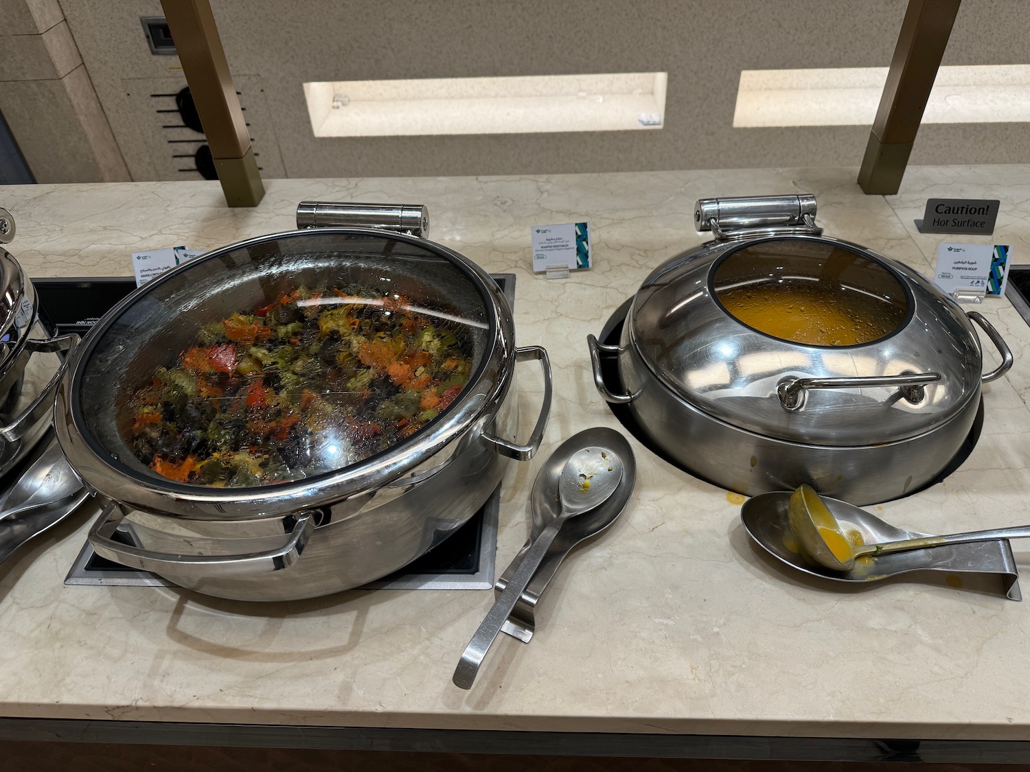 a two metal bowls with food in them