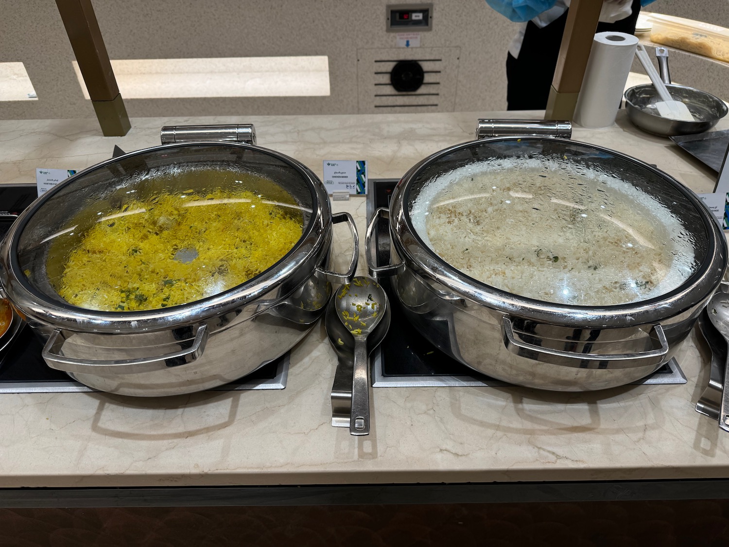 two large metal pots with food in them