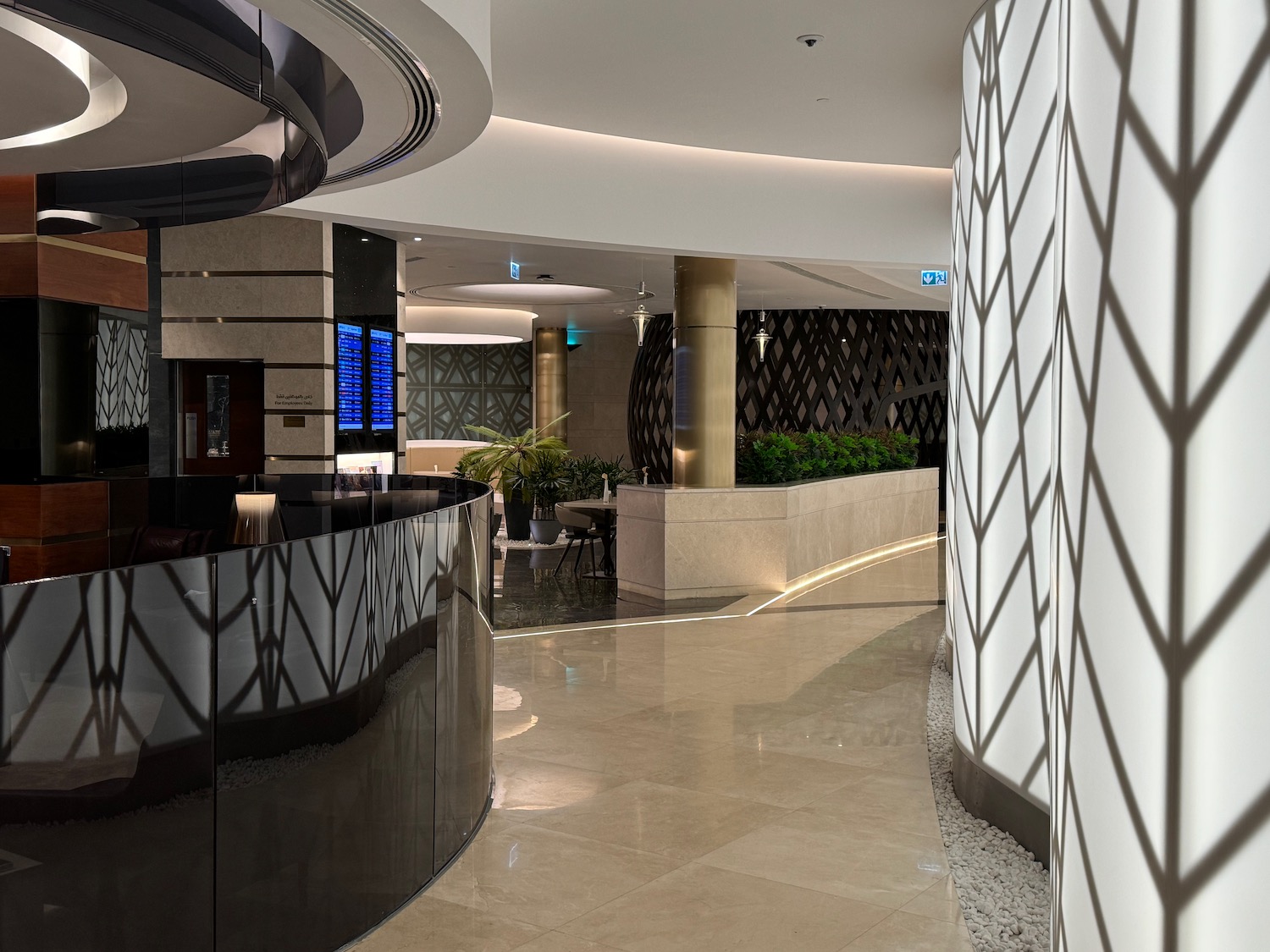 a lobby with a black counter and a white wall