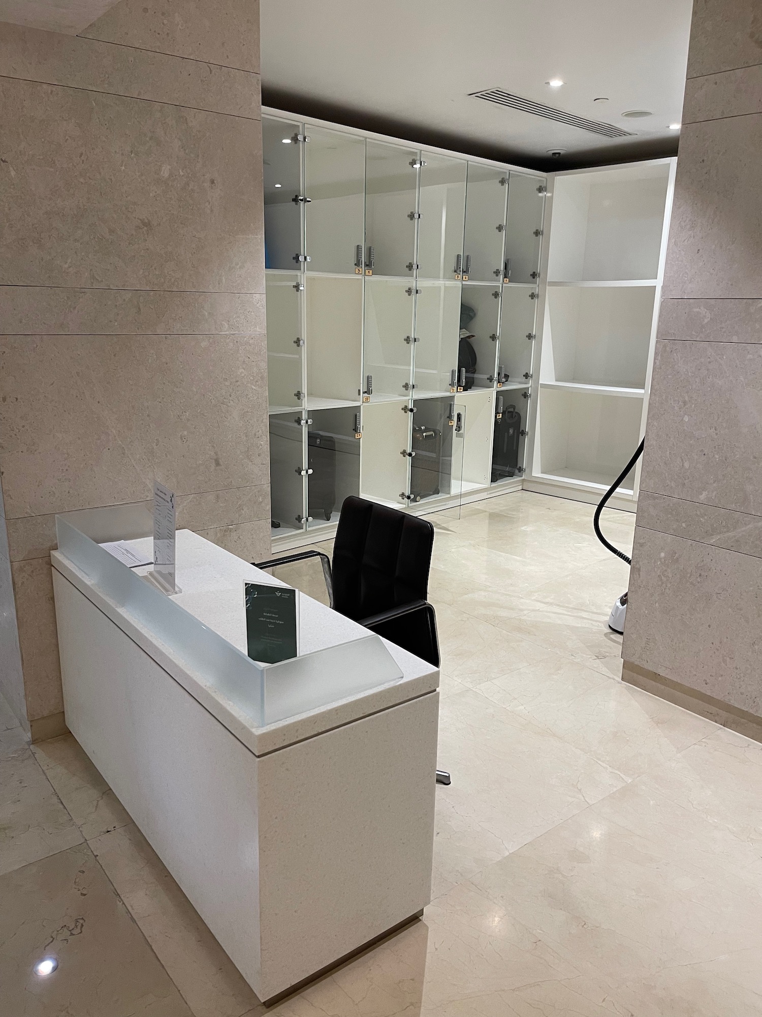 a desk and chair in a room with glass shelves