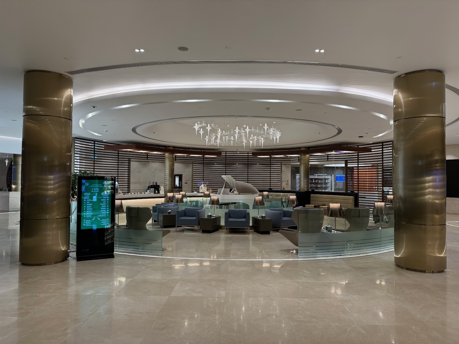 a lobby with a large round ceiling and a large chandelier