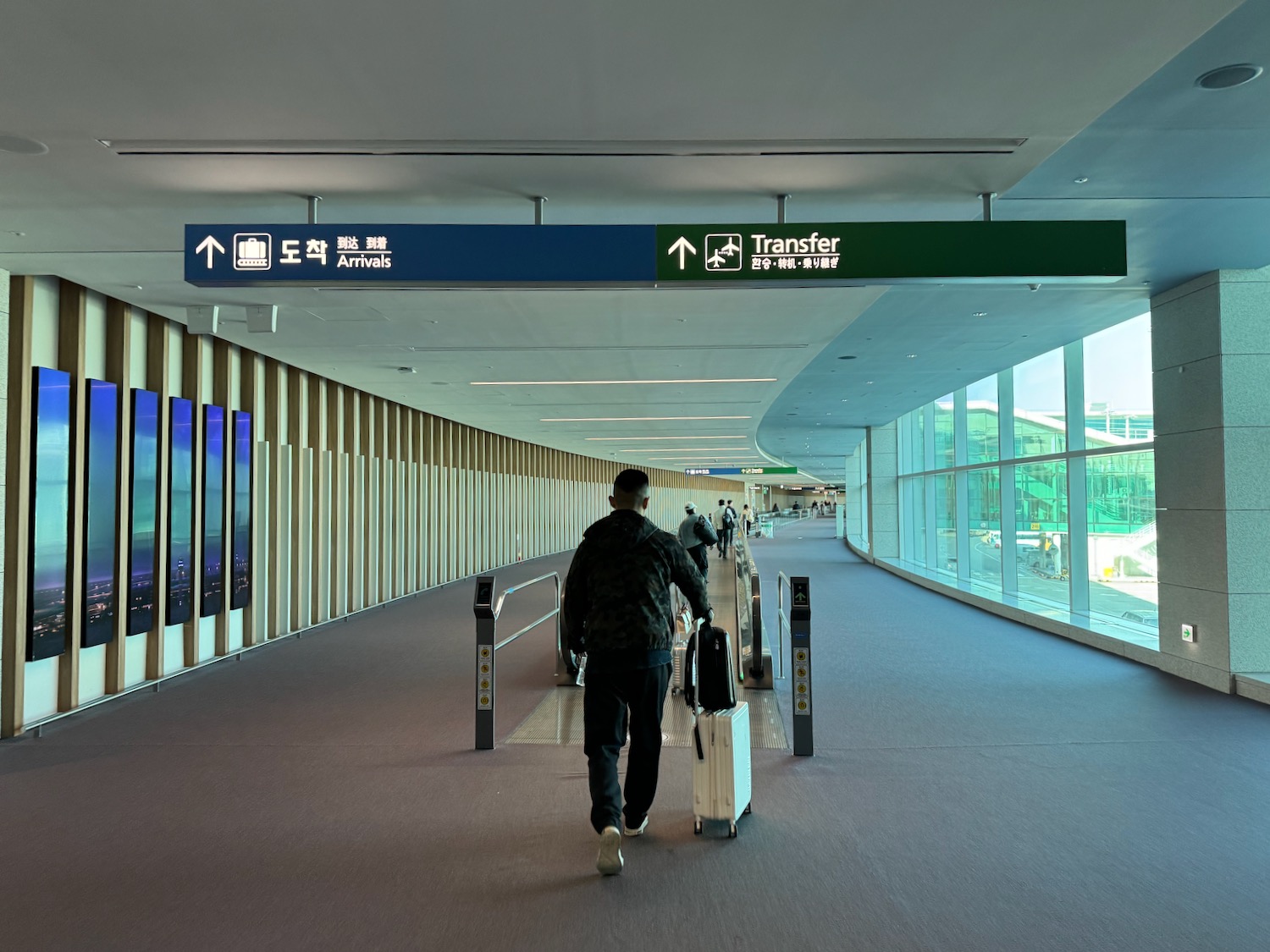 a man walking with luggage in an airport