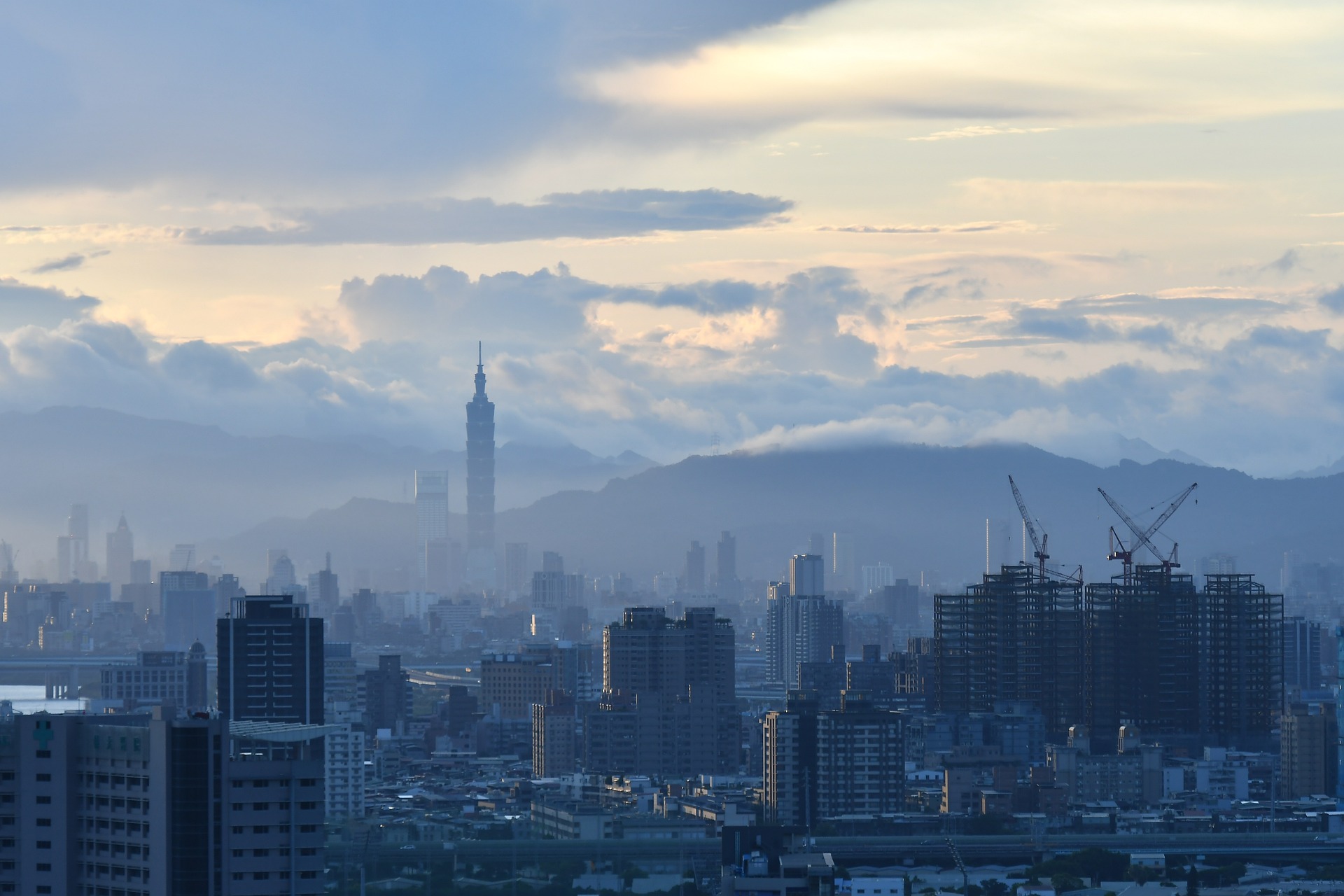 a city with tall buildings and mountains in the background