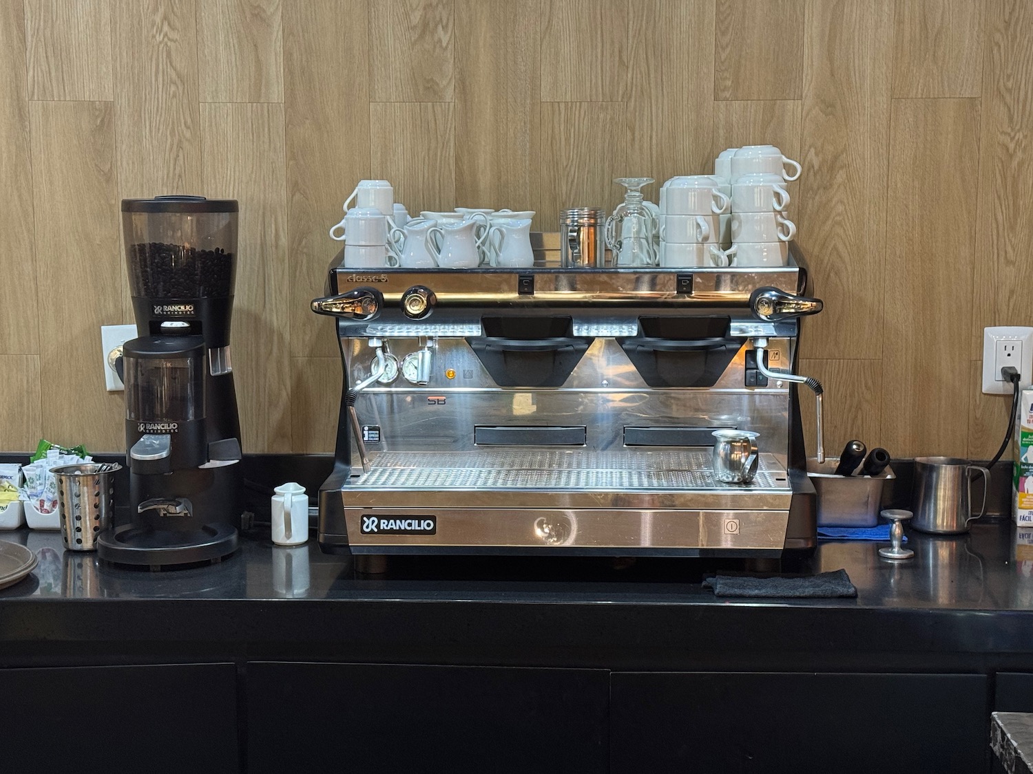 a coffee machine with white cups on top