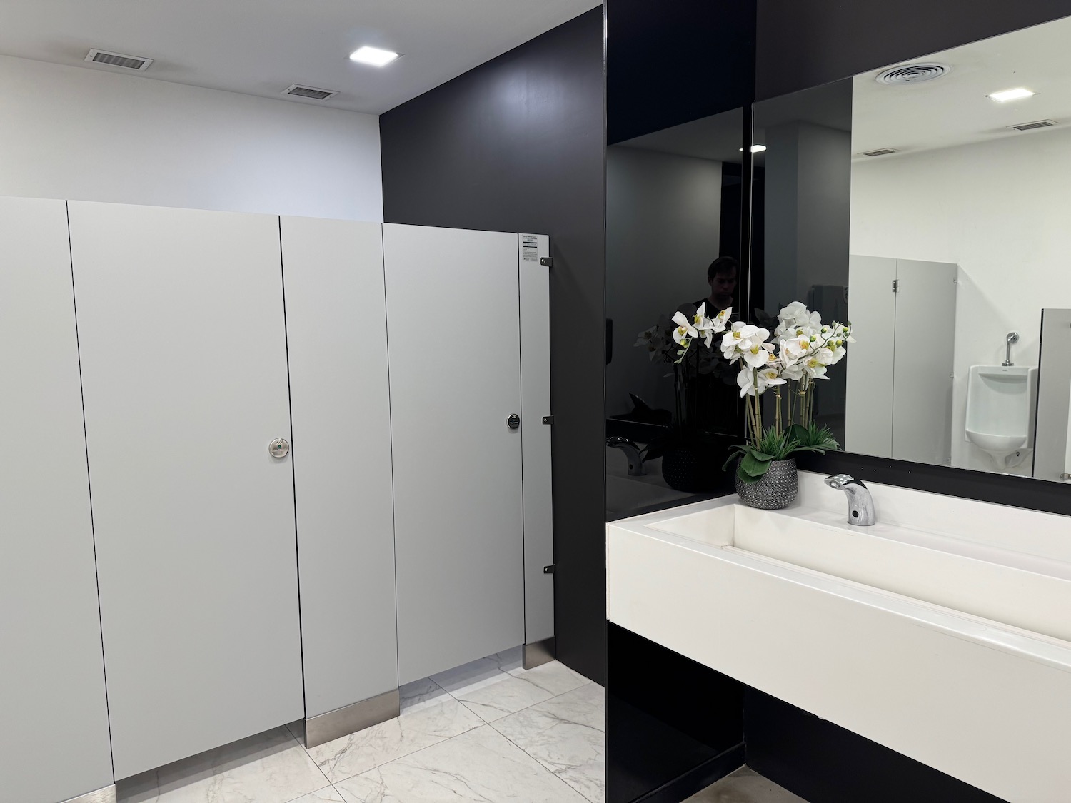 a bathroom with a sink and mirrors