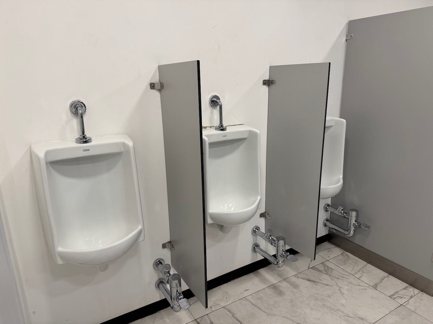 a row of urinals in a bathroom