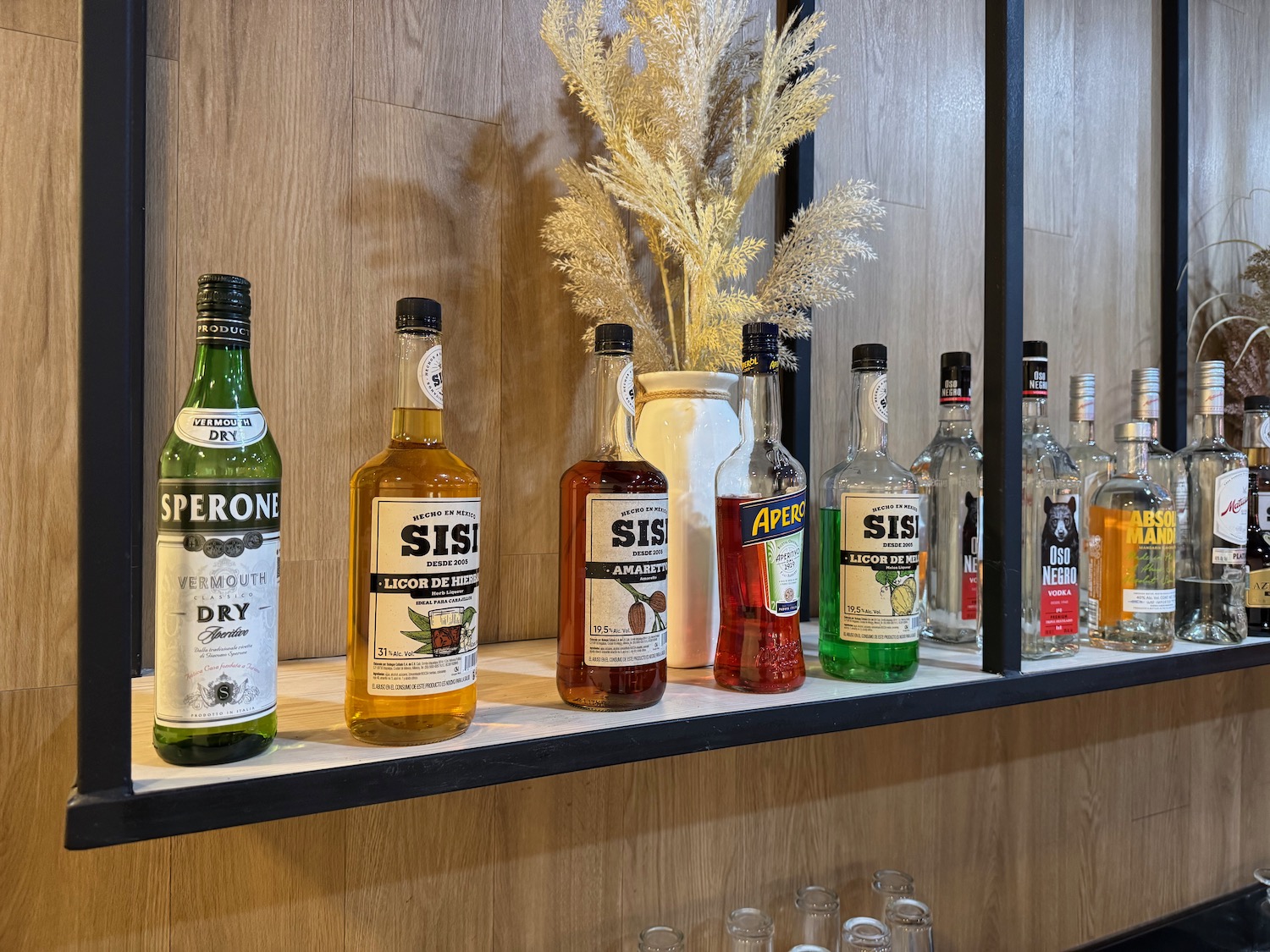 a shelf with bottles of liquor