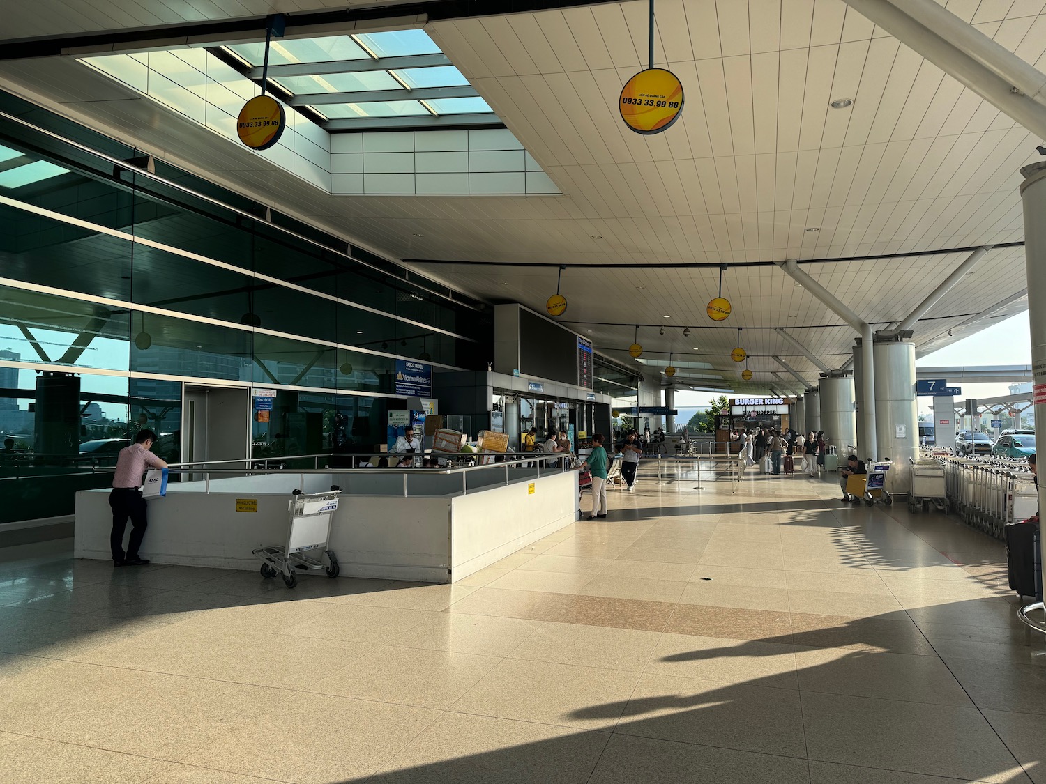 a large airport terminal with people walking and luggage