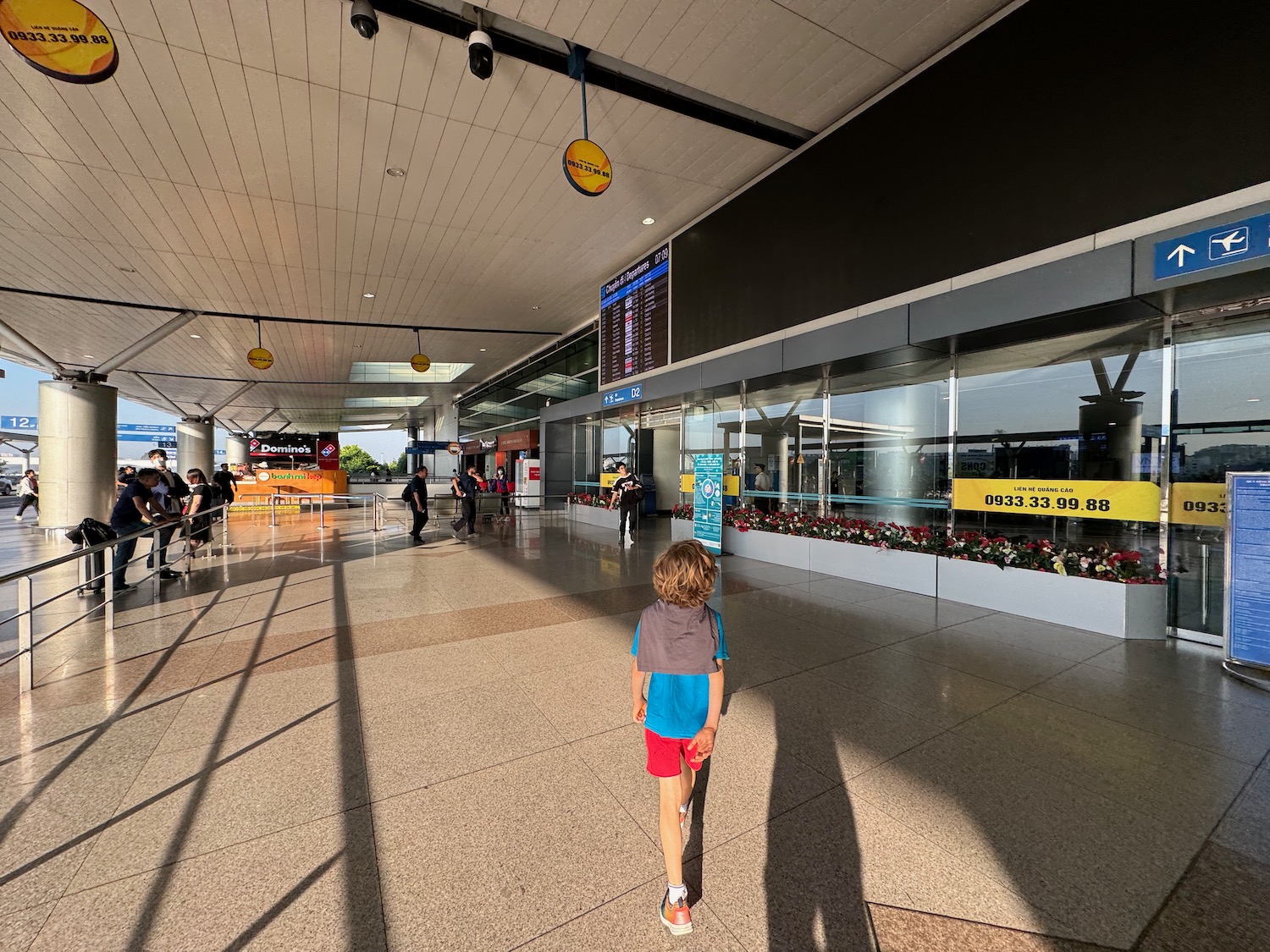 a boy walking in a large airport terminal