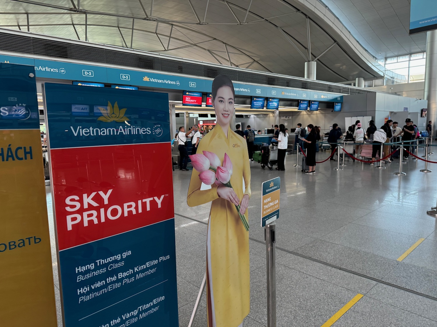 a cardboard cutout of a woman holding flowers in a airport