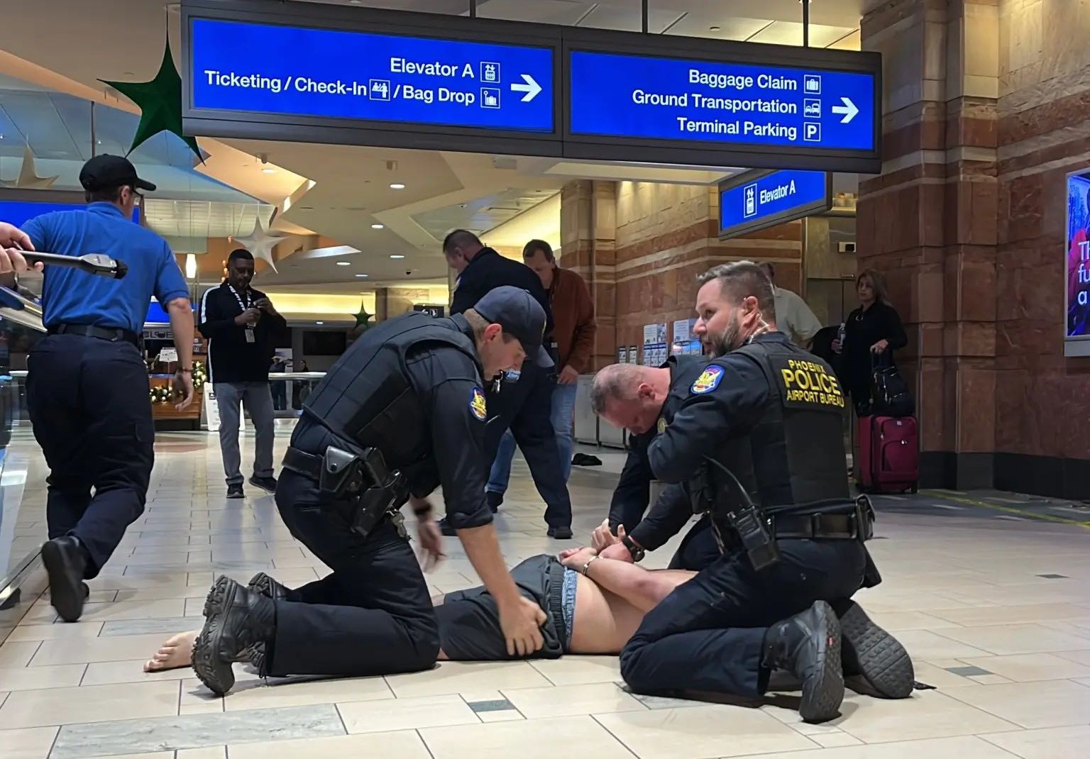 police officers helping another person to get on the ground