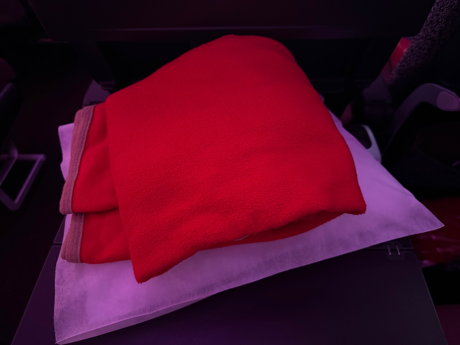 a red blanket on a white pillow