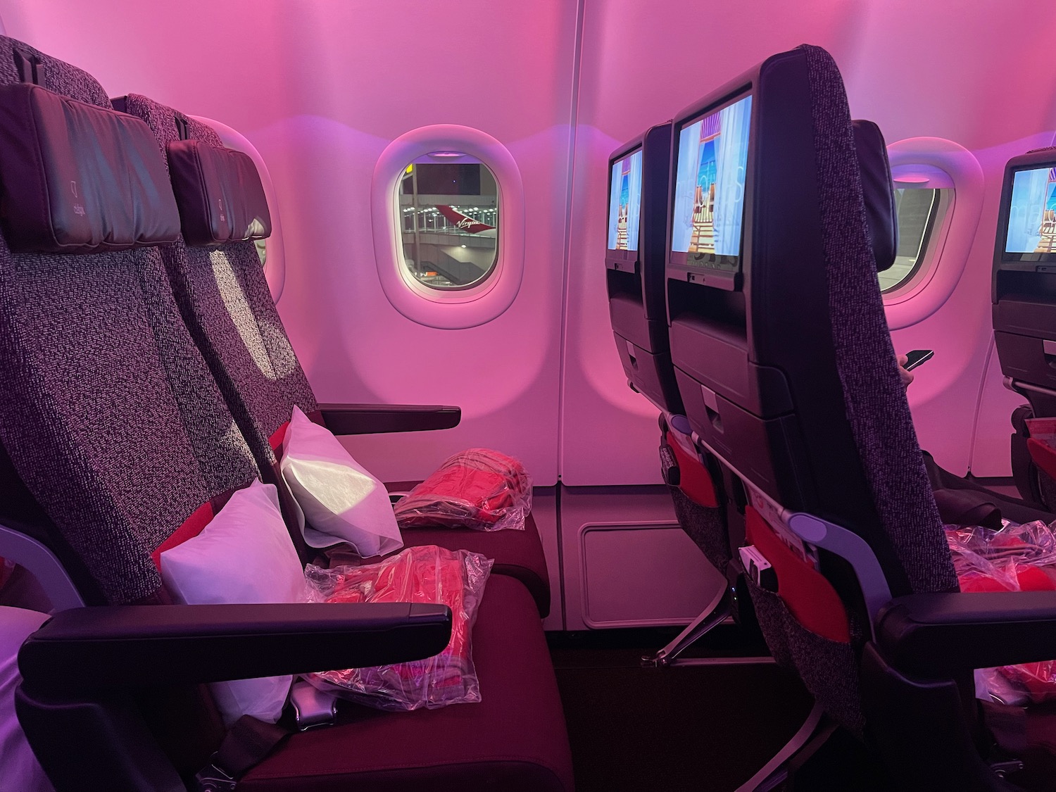 seats in an airplane with two monitors