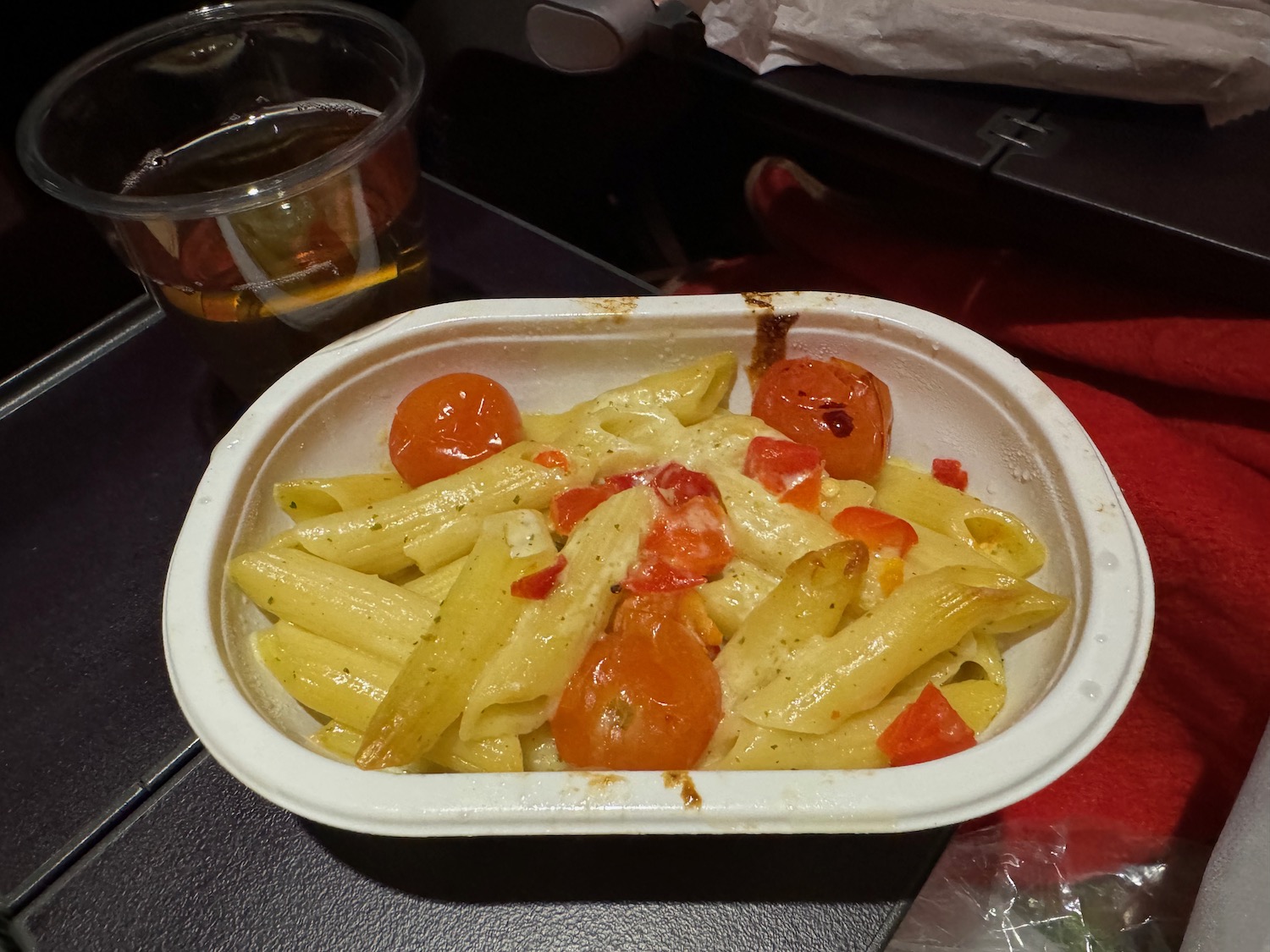 a pasta and tomatoes in a container