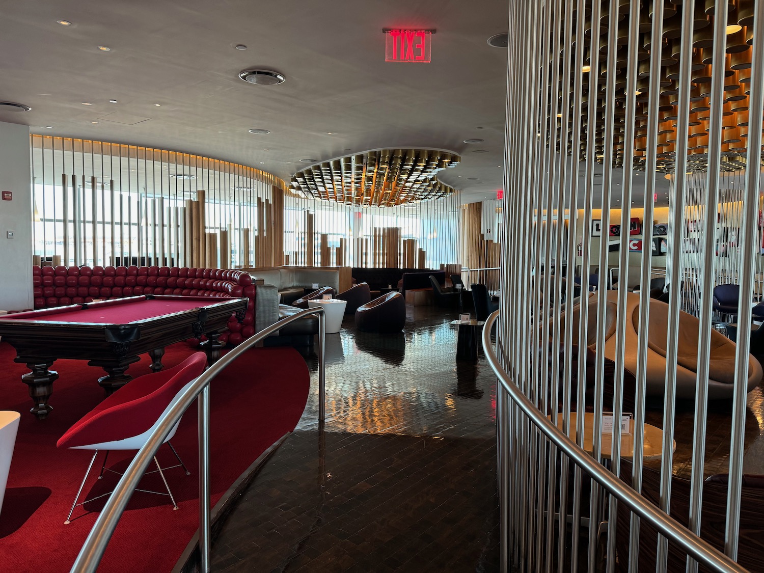 a room with a pool table and chairs