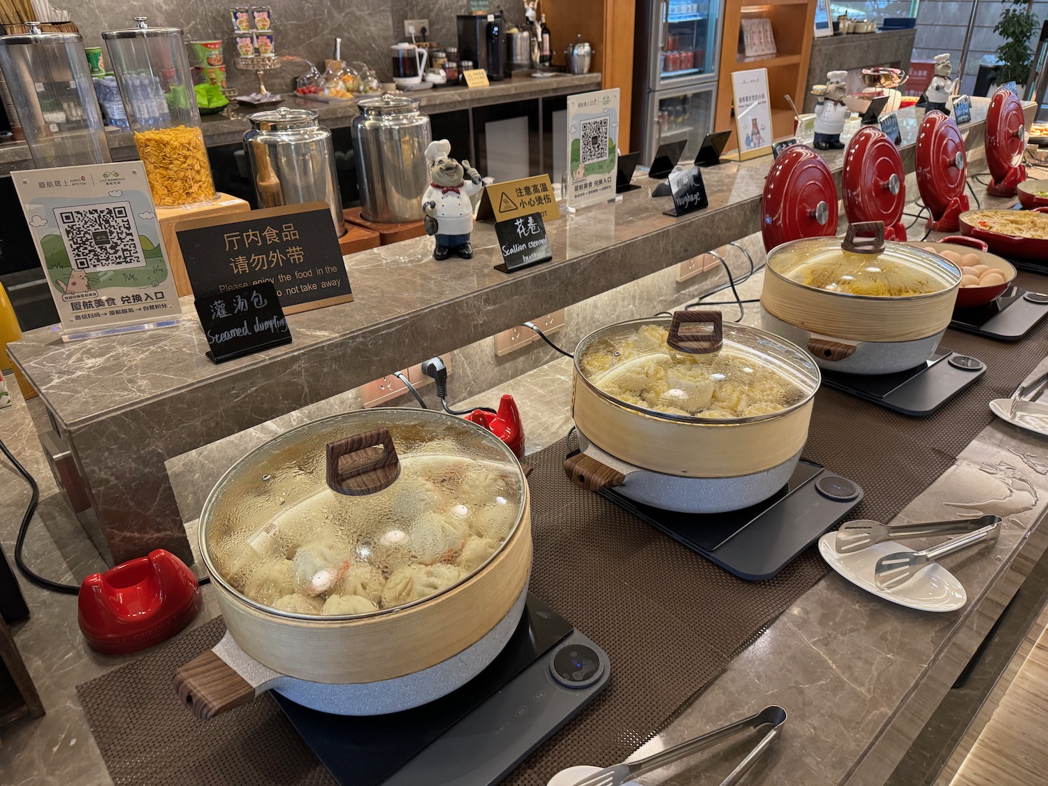 a row of bowls of food on a counter