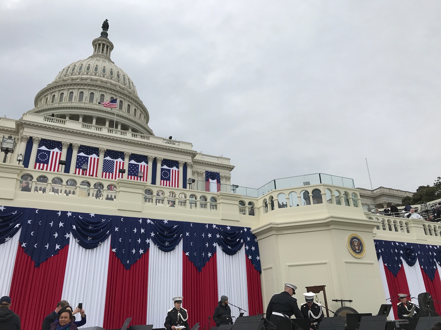 a band playing in front of a white building