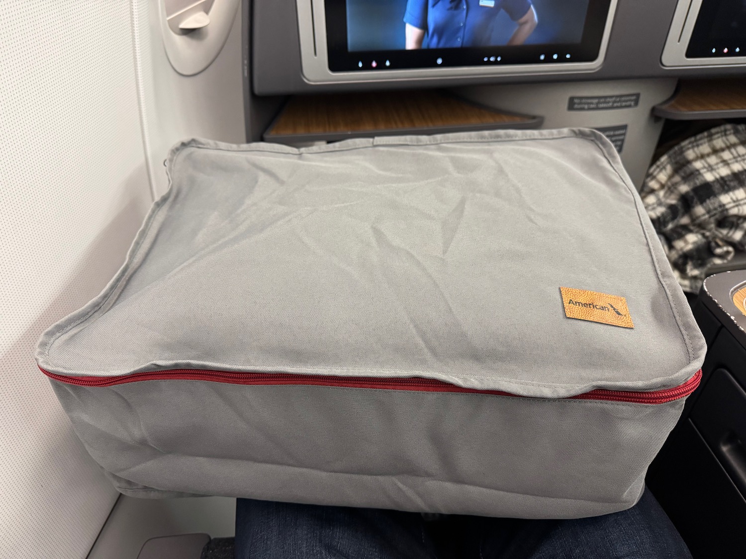 a grey pillow on a seat