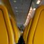 a row of yellow seats on an airplane