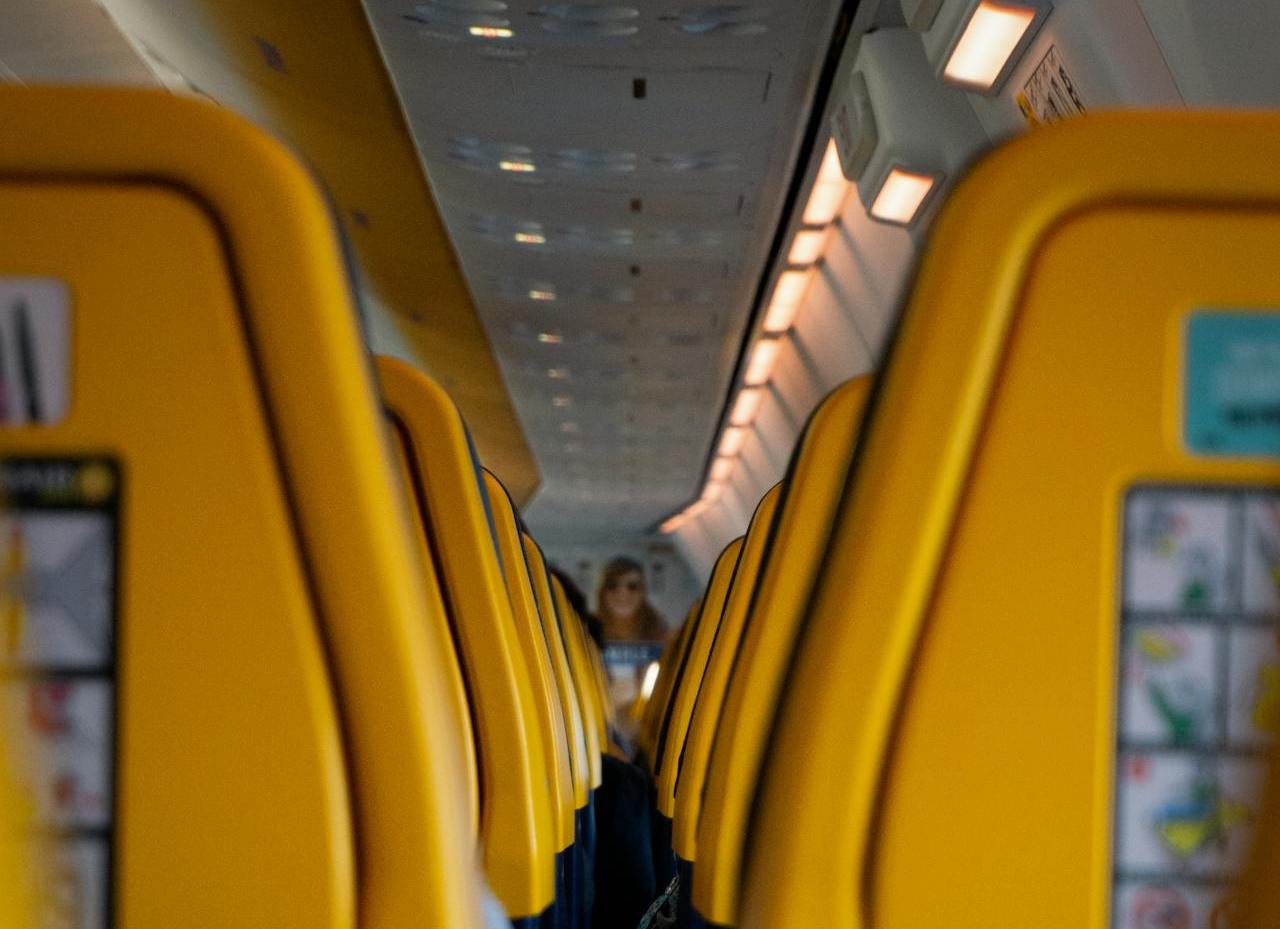 a row of yellow seats on an airplane