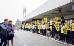 a group of people holding signs