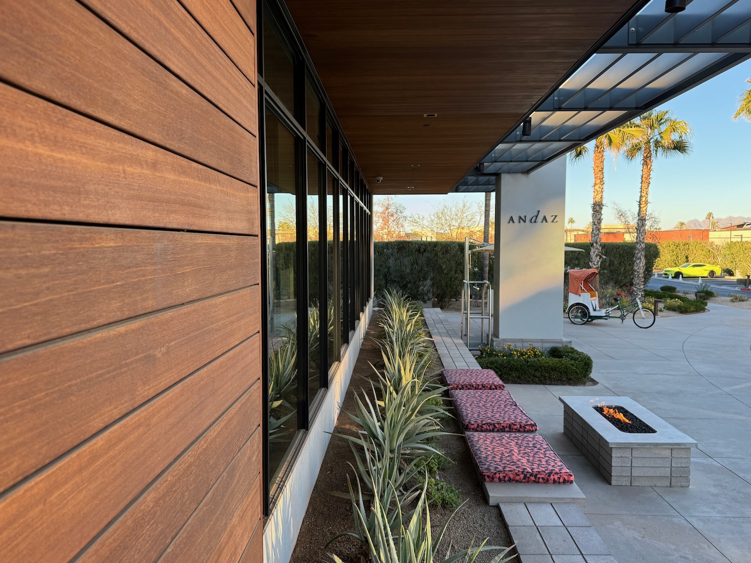 a building with a fire pit and a bicycle