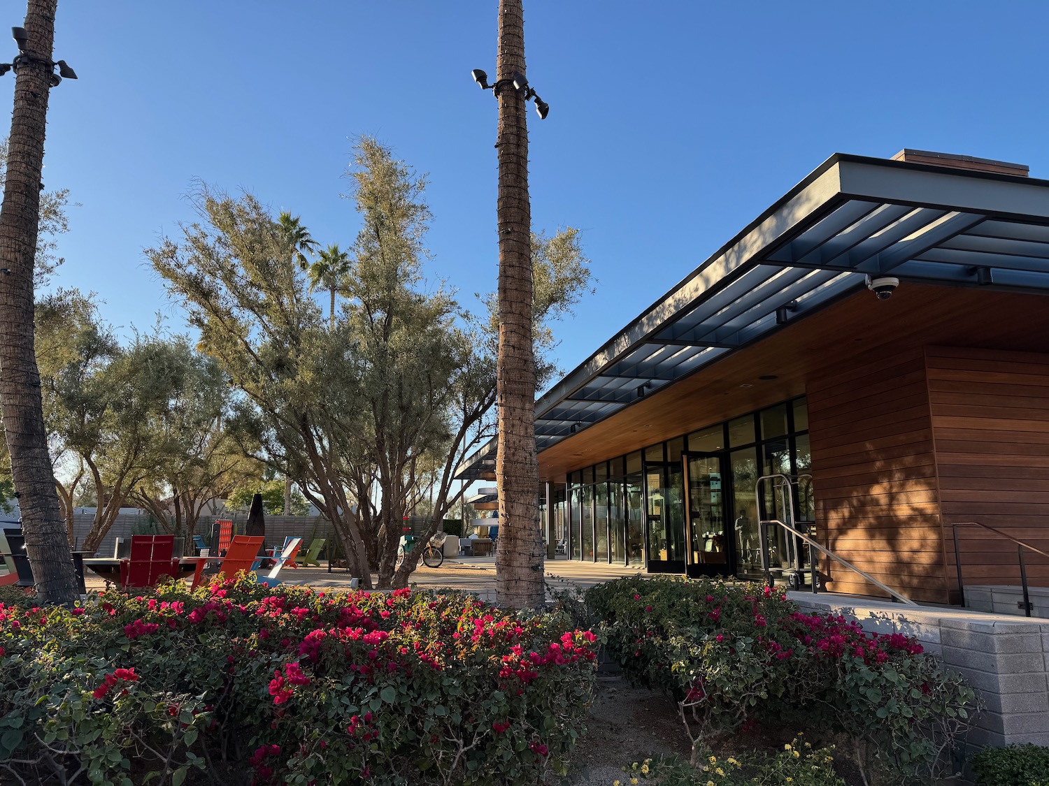 a building with a tree and flowers